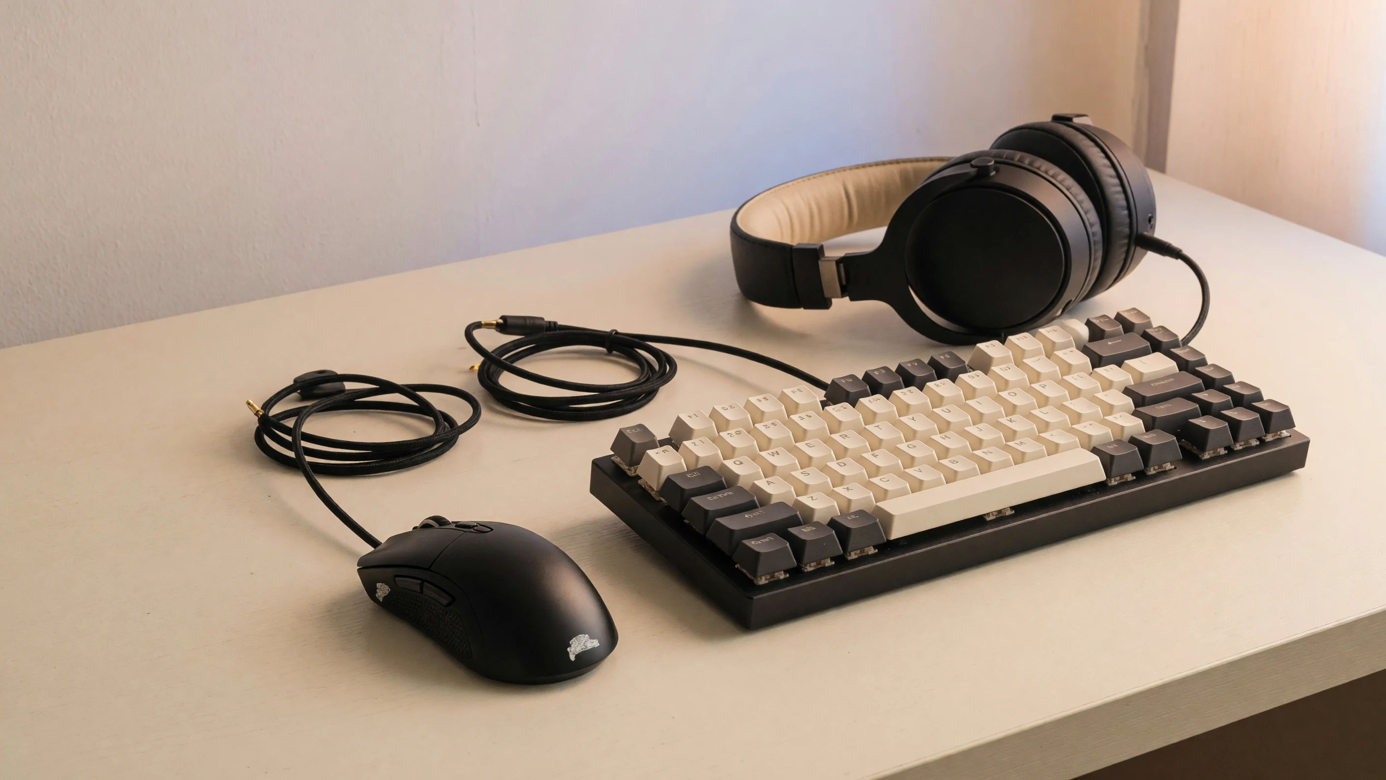 Editorial still life of FPS gaming gear on a cream desk