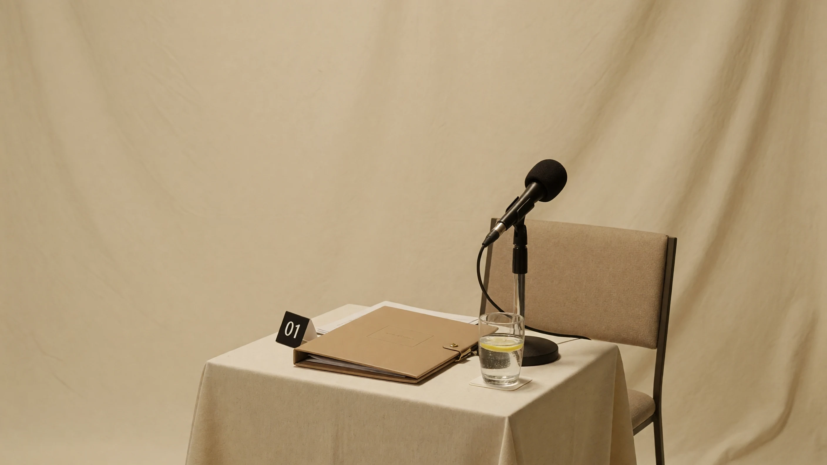 Wide editorial photograph of a post-match press area with player seating and media backdrop